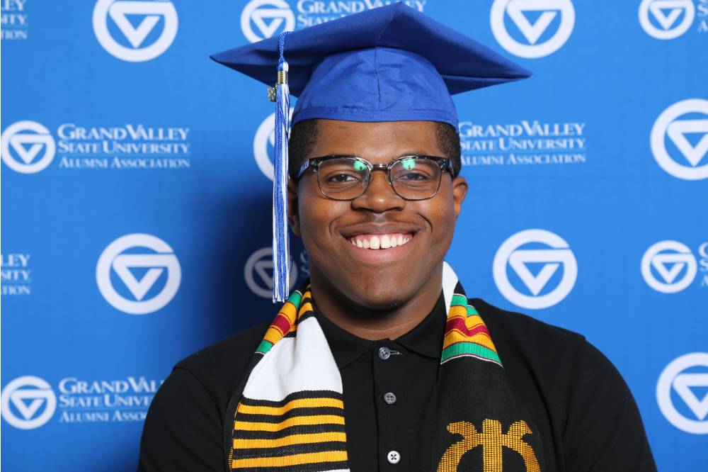 A future alumnus smiles for a photo at Gradfest